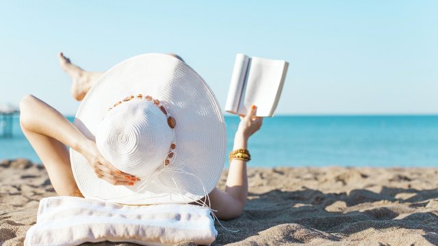 picture-of-woman-reading-a-book-on-the-beach-photo
