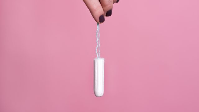 Woman's hand holding a tampon