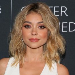 Sarah Hyland wears white on the red carpet.