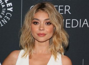 Sarah Hyland wears white on the red carpet.