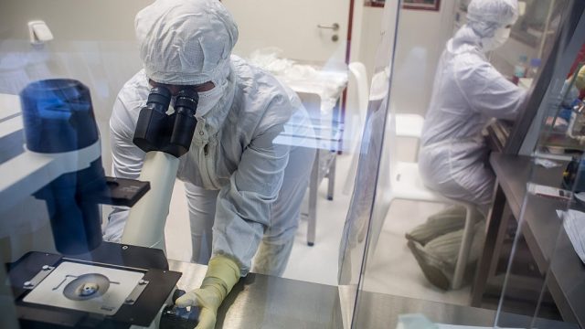 A laboratory specialist uses a microscope to check cells during the last phase of vaccine manufacture inside a clean laboratory at the Sotio AS biotechnology company in Prague, Czech Republic, on Wednesday, July 20, 2016. Czech Republics richest man, billionaire Petr Kellner's Sotio biotech company, which is seeking to develop active cellular immunotherapy for treatment of prostate, ovarian and lung cancer, has invested "billions of koruna" into research and clinical development, the unit's spokesman, Richard Kapsa, said without elaborating. Photographer: Martin Divisek/Bloomberg via Getty Images