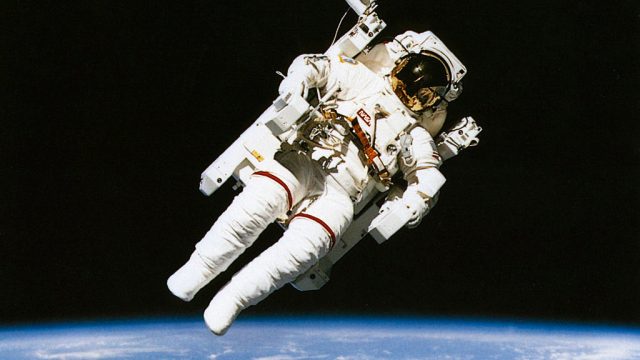 Astronaut floating in orbit above the earth during spacewalk