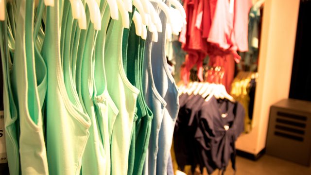 racks of clothing in a department store