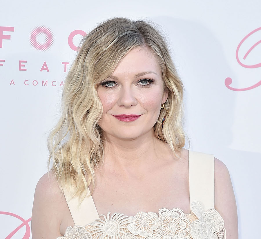 Kirsten Dunsts medium length hairstyle with bouncy curls