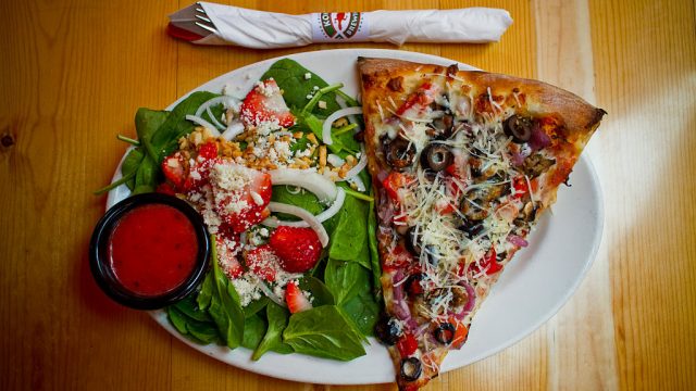 slice of pizza and salad