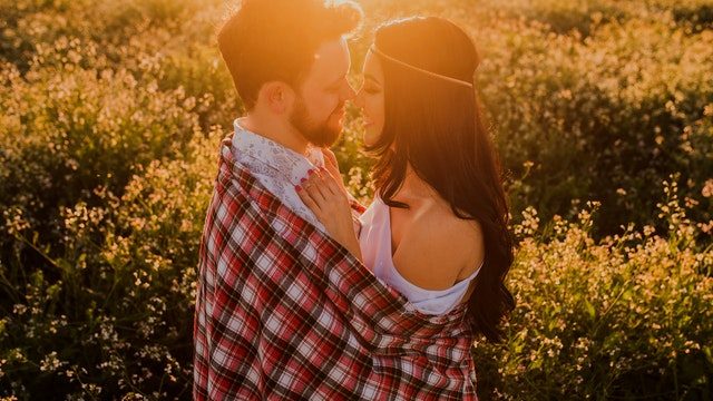 Couple hugging in a field