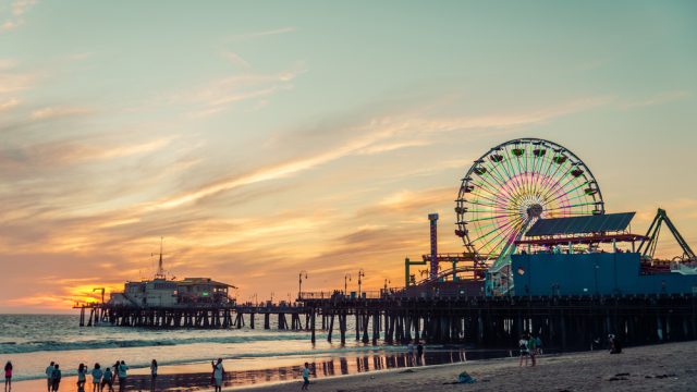 Santa Monica pier with beach and ferris wheel.