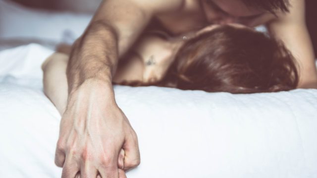 Man and woman having sex in bed