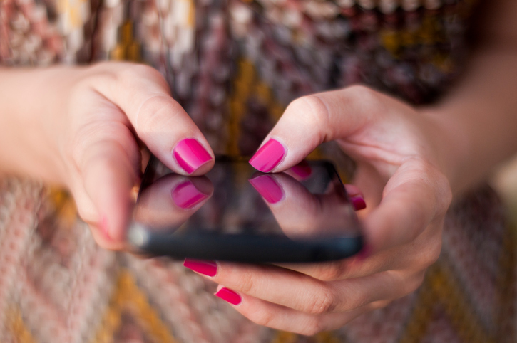 woman swiping on smartphone