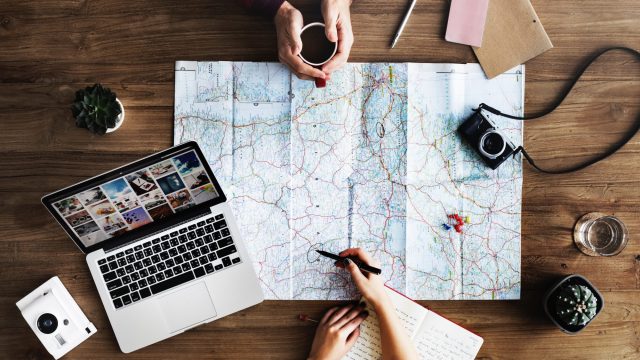 travel plans laptop map camera