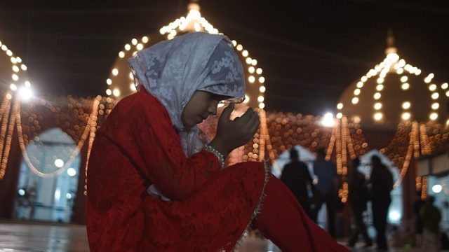 A young girl prays at a mosque