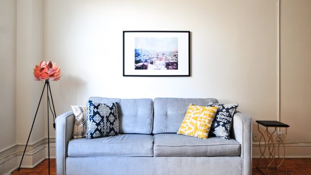 apartment furnished with gray couch pillows painting