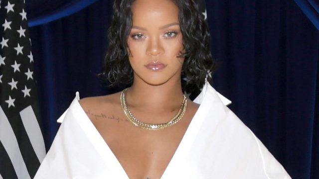 Image of Rihanna in open shoulder white top.