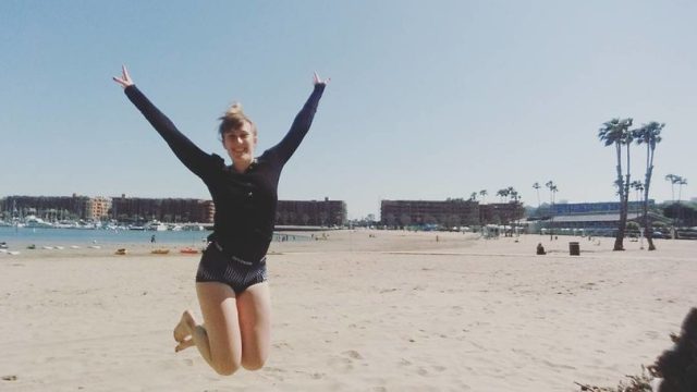 Author jumping on the beach