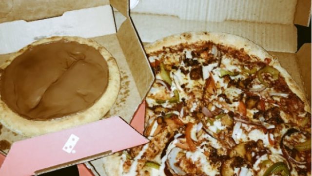 A Domino's chocolate pizza next to a regular Domino's pizza with toppings