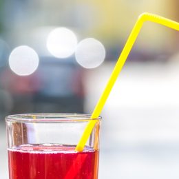Picture of a red drink with straw.