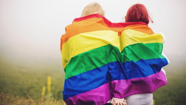 Women wrapped in pride flag