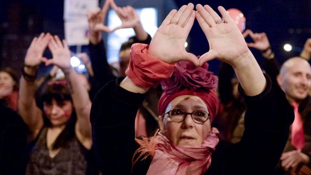 Demonstrator gestures during a rally for International Women's Strike. Marchers calling for the end of the violence on women and equal rights.
