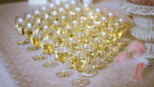 filled wine glasses on table