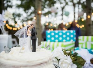 Bride and groom cake topper on cake