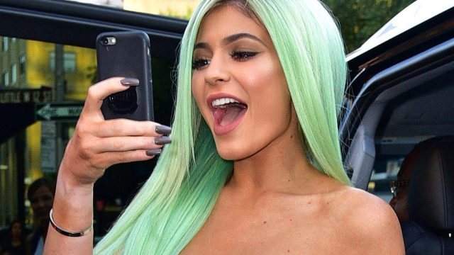 Kylie Jenner takes a photo on her phone