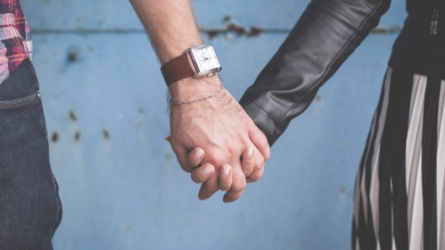 closeup shot of couple holding hands