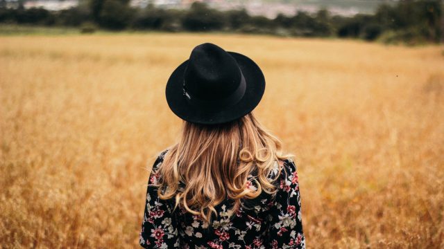 woman in field back turned to camera