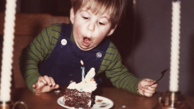 boy blowing out candles
