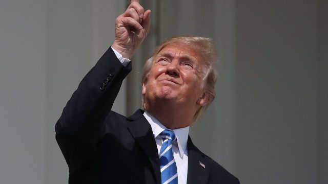 Image of Donald Trump looking at eclipse