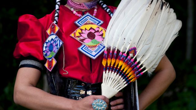 Indian Nation Pow Wow at Day Break Cultural Center in Discovery Park with woman posing with feather
