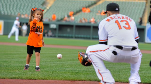 Hailey Dawson throwing out the first pitch at a baseball game