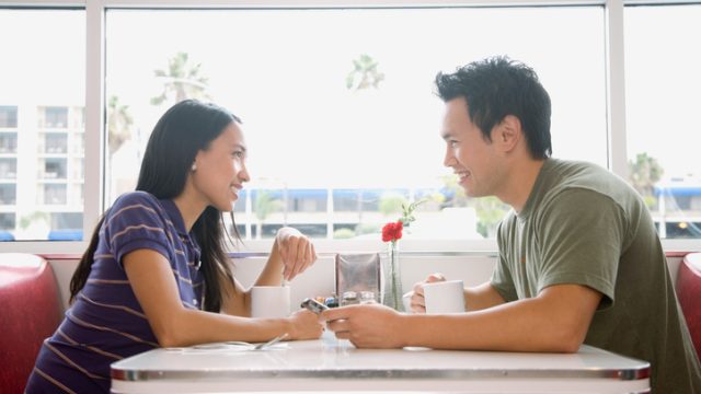 Asian couple smiling at each other