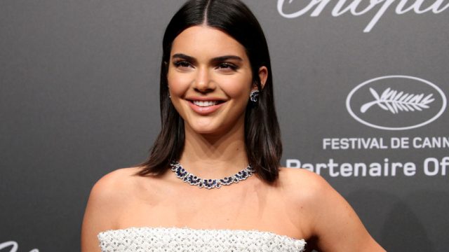 Kendall Jenner wears a white dress and diamond necklace on the red carpet