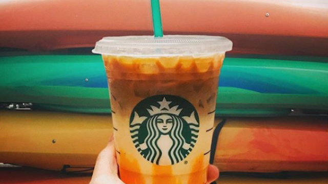 Picture of orange Starbucks drink against a colorful wall
