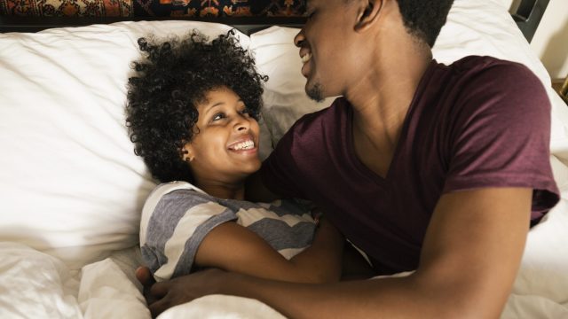 Couple playing in bed