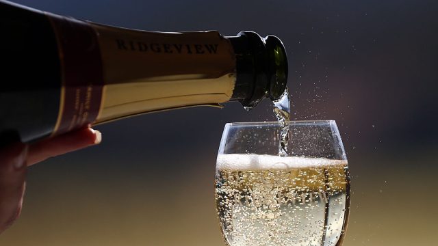 A glass of white wine is poured