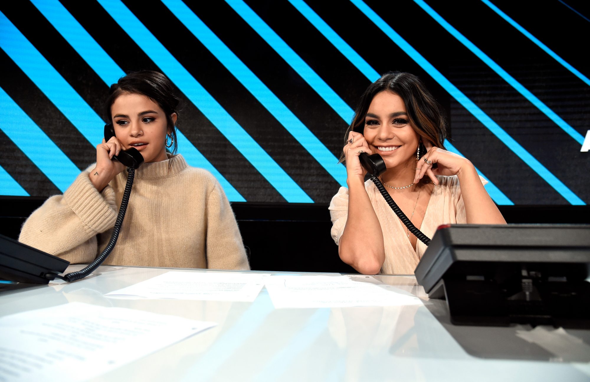 LOS ANGELES, CA - OCTOBER 14:  In this handout photo provided by One Voice: Somos Live!, Selena Gomez and Vanessa Hudgens participate in the phone bank onstage during