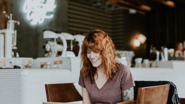 woman-with-red-hair-working-on-laptop