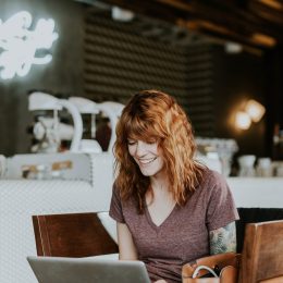 woman-with-red-hair-working-on-laptop