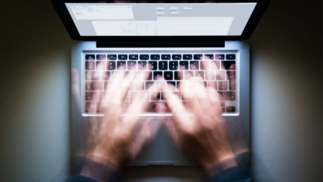 Man typing on laptop