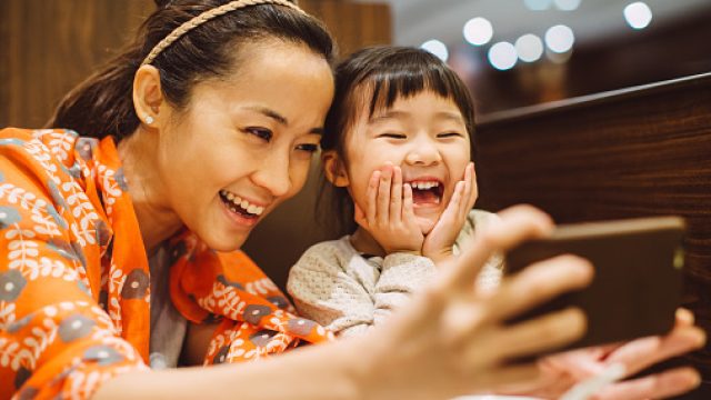 mom and child taking selfies