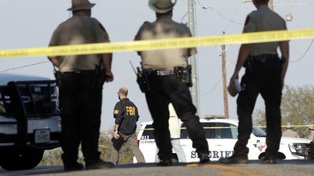 SUTHERLAND SPRINGS, TX - NOVEMBER 5: Law enforcement officials gather near the First Baptist Church following a shooting on November 5, 2017 in Sutherland Springs, Texas. At least 20 people were reportedly killed and 24 injured when a gunman, identified as Devin P. Kelley, 26, allegedly entered the church during a service and opened fire. (Photo by Erich Schlegel/Getty Images)