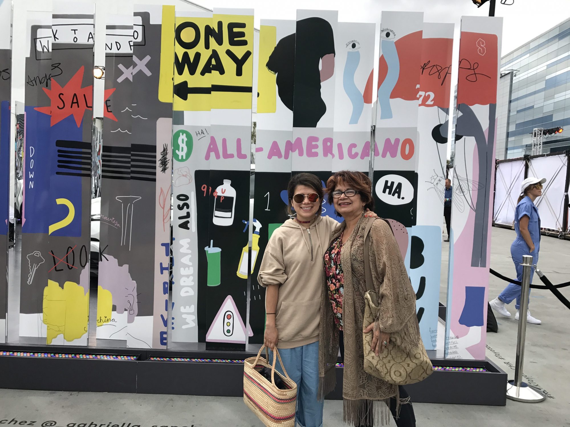 Sanchez with her mother in front of her mural at L.A. Live