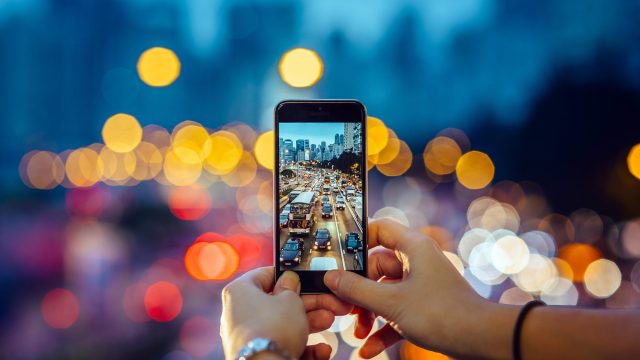 Image of woman taking photo on phone