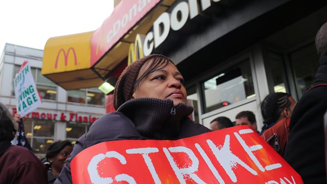 Fast food workers and their supporters participate in a one day walk out, rally, and march to a McDonald's in harlem to protest the low pay of minimum wage, saying that it $7.25 an hour in New York City is not a livable salary. Organizers estimated that several hundred fast food workers from chains across the city joined the walk out. (Photo by Andrew Lichtenstein/Corbis via Getty Images)