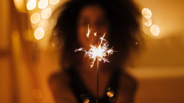Girl holds Christmas sparkles