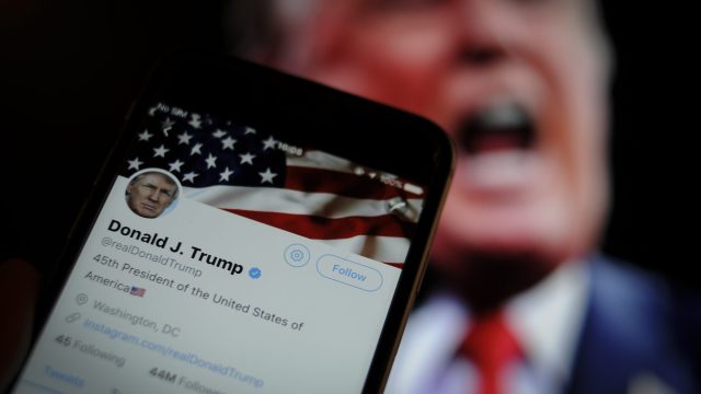 Photo of Twitter App with Donald Trump in the Background
