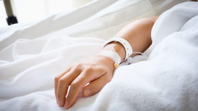 Image of person's hand in hospital