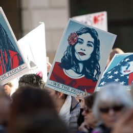 Demonstrators hold signs during the Women's March of Los Angeles