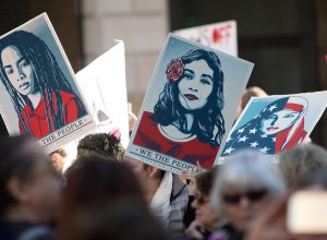 Demonstrators hold signs during the Women's March of Los Angeles